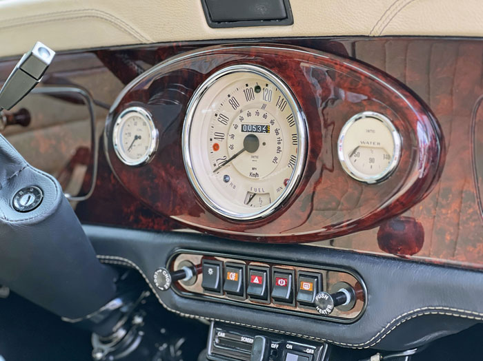 Classic Mini dashboard with a custom 3-clock center and premium finish.