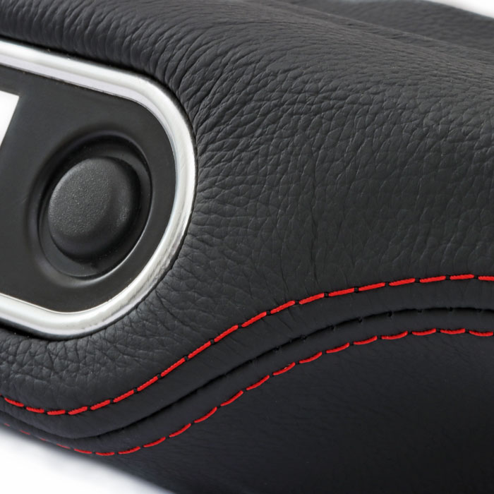 Bespoke dash pad for a classic Mini, finished in black leather with bold red stitching.