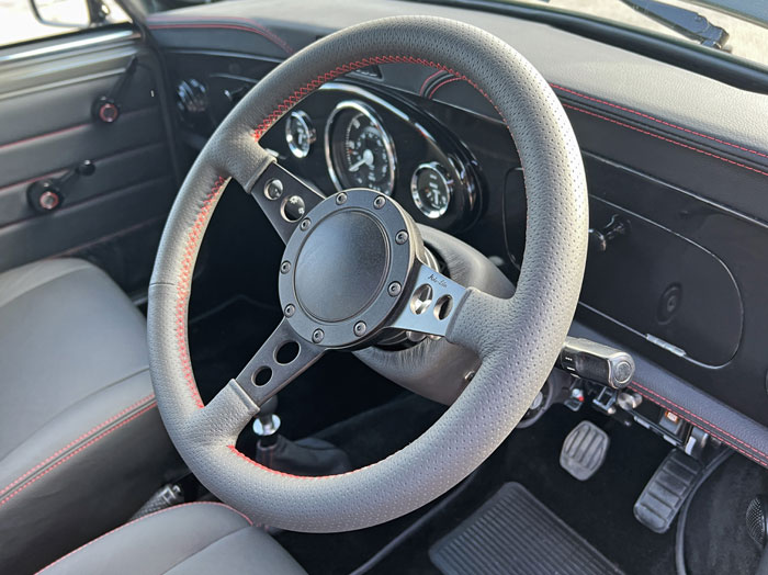 Bespoke Moto-Lita steering wheel crafted for a classic Mini with luxurious leather finish.