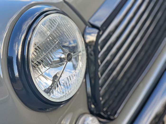 Close-up of the P700 headlamp with black chrome accents: Close-up of the P700 headlamp with sleek black chrome detailing on the Mini Spectre.