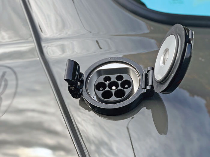 Black EV charging port on the Mini Spectre, reflecting its modern electric capabilities.