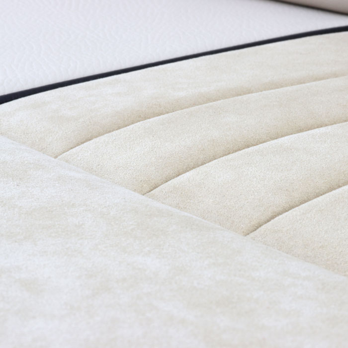 Close-up of custom Alcantara seats in a classic Mini, showcasing luxurious material and precise stitching.