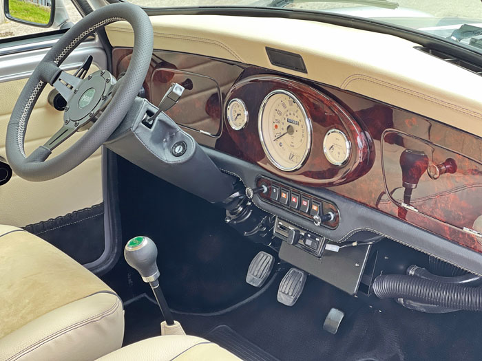 Custom wooden dashboard in a classic Mini featuring a 3-clock center and high-quality craftsmanship.