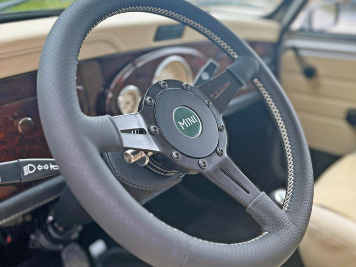 Moto-Lita steering wheel in a classic Mini, equipped with a quick-release steering boss for added functionality.