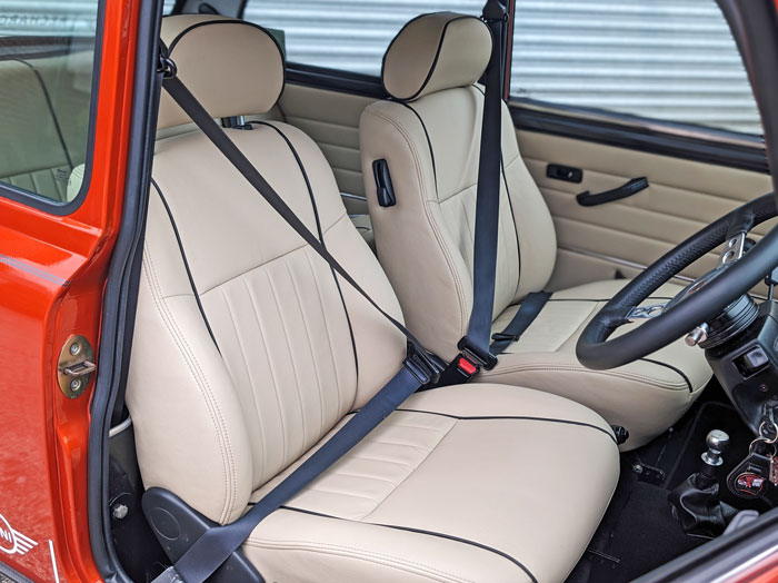 Cream leather seats in a classic Mini restored to their original condition with expert repair work.