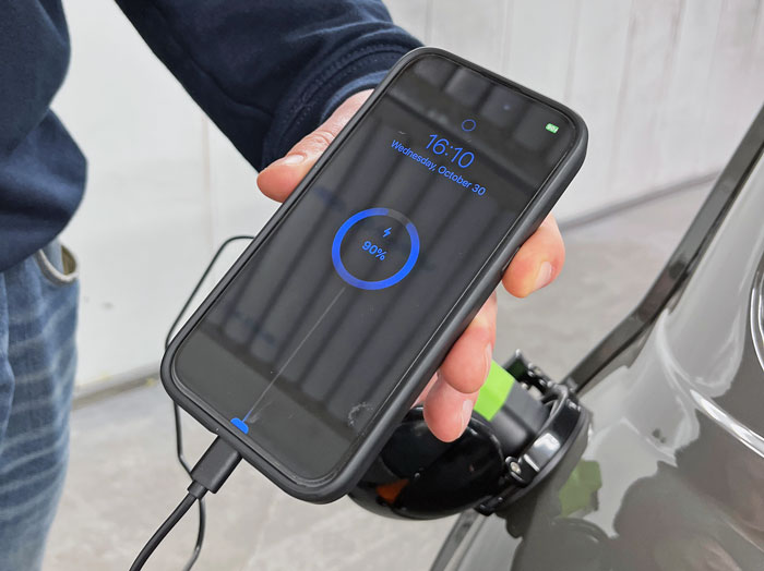 Mobile phone being charged using the Mini Spectre’s bi-directional charging technology.