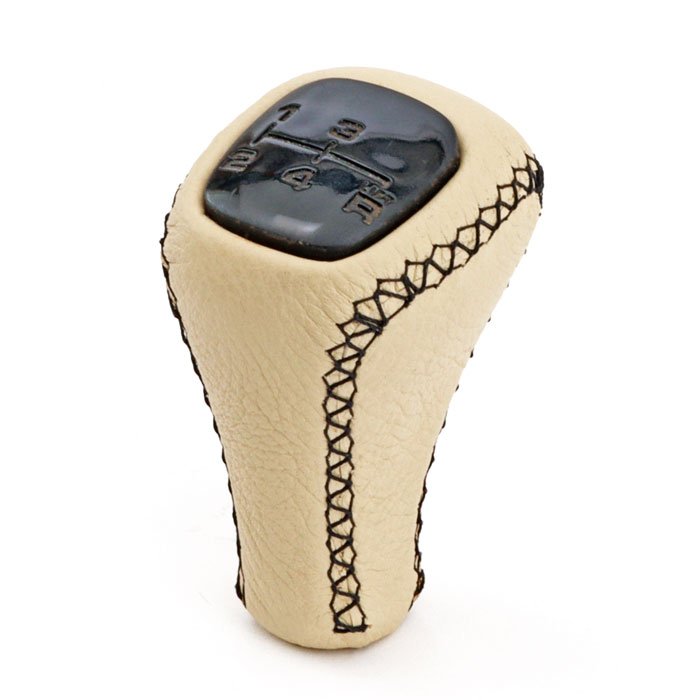Classic Mini gearknob restored with new leather covering, showcasing a sleek and refined finish.