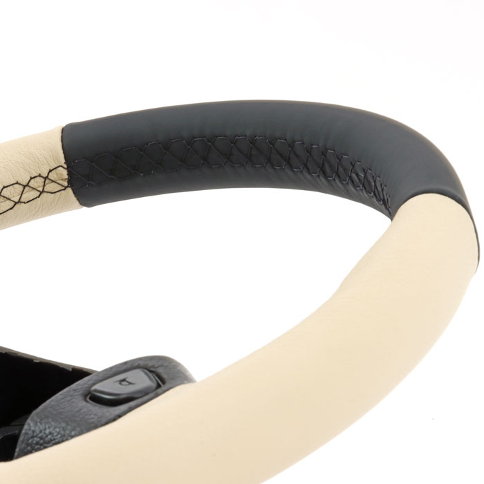 Close-up of a classic Mini steering wheel, expertly recovered in premium leather with precise stitching.