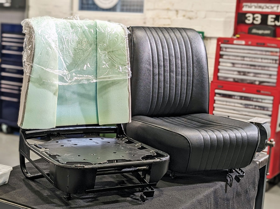 A classic Mini seat frame with new cushion material next to a fully reupholstered seat in matching fabric.