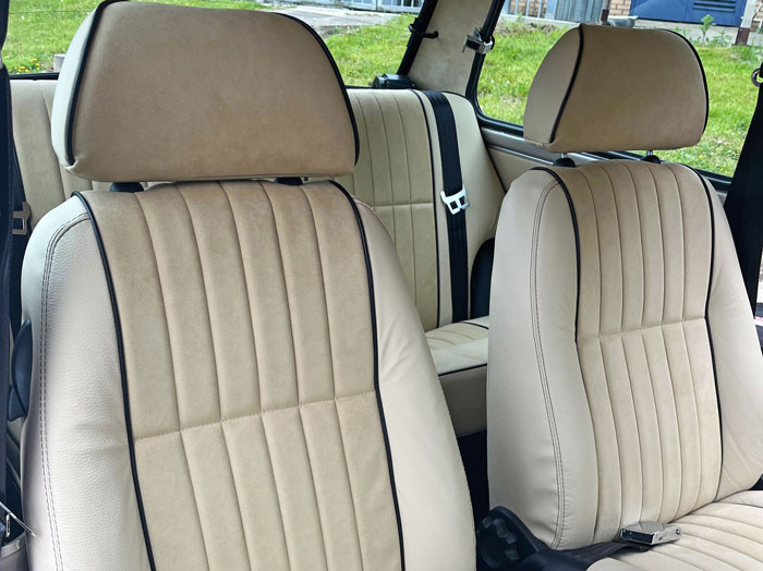 Alcantara seats fitted into a restored classic Mini, showcasing high-end materials and design.