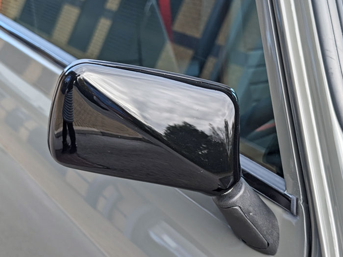 Close-up of the black wing mirror, adding a sleek touch to the Mini Spectre’s exterior.